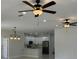 Bright and airy living room showcasing the kitchen with stainless steel appliances at 3431 Orchid Dr, Indian Lake Estates, FL 33855