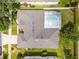 Aerial view of a well maintained property with nice roof, mature landscaping, and a screened in pool at 3711 Half Moon Dr, Orlando, FL 32812