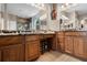 Bathroom with granite counters, a vanity with two mirrors, and a makeup area at 3711 Half Moon Dr, Orlando, FL 32812