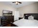 Bedroom featuring dark wood floors, a television and a queen sized bed at 3711 Half Moon Dr, Orlando, FL 32812