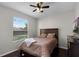 Well-lit bedroom with a large window, hardwood floors and updated ceiling fan at 3711 Half Moon Dr, Orlando, FL 32812