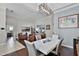 Dining area featuring hardwood floors, modern lighting, and a view into the living space at 3711 Half Moon Dr, Orlando, FL 32812
