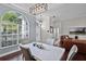 Dining area with modern light fixture, hardwood floors, and views of the entrance at 3711 Half Moon Dr, Orlando, FL 32812