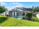 Exterior back of house with large patio and pool at 3711 Half Moon Dr, Orlando, FL 32812