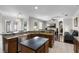 Open kitchen with stainless steel appliances, granite countertops, and a breakfast bar overlooking the living room at 3711 Half Moon Dr, Orlando, FL 32812