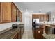 Spacious kitchen with stainless appliances, granite counters, wood cabinets, and center island at 3711 Half Moon Dr, Orlando, FL 32812
