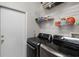 Modern laundry room features front loading washer and dryer and metal shelving at 3711 Half Moon Dr, Orlando, FL 32812