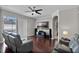 Open living room area with backyard pool view, TV, hardwood floors, and neutral paint at 3711 Half Moon Dr, Orlando, FL 32812