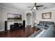 Comfortable living room with media center, hardwood floors, and neutral paint at 3711 Half Moon Dr, Orlando, FL 32812