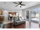 Inviting living room with hardwood floors, ceiling fan and sliding doors leading to the pool area at 3711 Half Moon Dr, Orlando, FL 32812