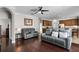 Spacious living room with hardwood floors, comfortable leather seating, and an open layout at 3711 Half Moon Dr, Orlando, FL 32812