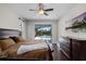 Main bedroom with wood floors, a ceiling fan, a screened patio, and a TV at 3711 Half Moon Dr, Orlando, FL 32812