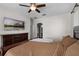 Spacious main bedroom with wood floors, ceiling fan, TV, and bathroom access at 3711 Half Moon Dr, Orlando, FL 32812