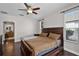 Comfortable main bedroom with wood floors, ceiling fan, and bathroom access at 3711 Half Moon Dr, Orlando, FL 32812