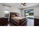 Spacious main bedroom with wood floors, a ceiling fan, and screened patio access at 3711 Half Moon Dr, Orlando, FL 32812