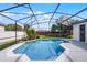 Sparkling pool is surrounded by a screened enclosure with lush greenery at 3711 Half Moon Dr, Orlando, FL 32812