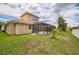 Home's backyard features a screened-in pool and lush green grass at 3816 Eagle Isle Cir, Kissimmee, FL 34746