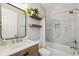 Charming bathroom features floating wood shelves, stylish fixtures, and tiled shower over tub at 3816 Eagle Isle Cir, Kissimmee, FL 34746