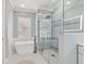 Elegant bathroom featuring a soaking tub, glass-enclosed shower, and double sink vanity at 3816 Eagle Isle Cir, Kissimmee, FL 34746