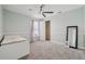 Bright bedroom featuring plush carpeting, ceiling fan, and a mirror at 3816 Eagle Isle Cir, Kissimmee, FL 34746