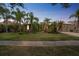 Exterior view of home with manicured lawn and mature trees at dusk at 3816 Eagle Isle Cir, Kissimmee, FL 34746