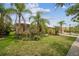 Well-manicured front yard with lush landscaping and palm trees at 3816 Eagle Isle Cir, Kissimmee, FL 34746