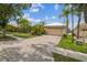 Two-car garage with paved driveway and manicured landscaping at 3816 Eagle Isle Cir, Kissimmee, FL 34746