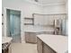 Well-lit kitchen features a center island, stainless steel refrigerator, and ample cabinet space at 3816 Eagle Isle Cir, Kissimmee, FL 34746