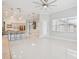 Bright living room features an open floorplan, tile floors, and large windows for ample natural light at 3816 Eagle Isle Cir, Kissimmee, FL 34746