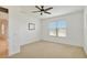 Bright bedroom with large window, ceiling fan, neutral carpet and white walls, offering a serene and inviting space at 3906 Carrick Bend Dr, Kissimmee, FL 34746