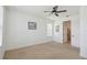 Bedroom with ceiling fan and open doorway that leads to a bathroom with tiled floors at 3906 Carrick Bend Dr, Kissimmee, FL 34746