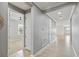 Hallway with tile floors, neutral paint, white trim, and access to bedrooms at 3906 Carrick Bend Dr, Kissimmee, FL 34746