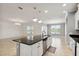Open concept kitchen with a granite countertop island, stainless steel appliances and lots of natural light at 3906 Carrick Bend Dr, Kissimmee, FL 34746