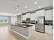 Spacious open kitchen with white cabinets, stainless steel appliances, granite countertops, and large island at 3906 Carrick Bend Dr, Kissimmee, FL 34746