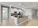 Open kitchen featuring tile floors, white cabinets, granite countertops, stainless appliances, and center island at 3906 Carrick Bend Dr, Kissimmee, FL 34746