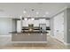 Bright kitchen with granite countertops, stainless steel appliances, white cabinetry and large island at 3906 Carrick Bend Dr, Kissimmee, FL 34746