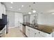 Well lit kitchen features stainless steel appliances, island with granite countertops and undermount sink at 3906 Carrick Bend Dr, Kissimmee, FL 34746