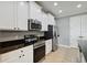 Bright kitchen showcasing white cabinets, granite countertops, stainless appliances, and tile floors at 3906 Carrick Bend Dr, Kissimmee, FL 34746