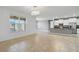 Spacious open living room area leads into an open concept kitchen with tile floors and modern finishes at 3906 Carrick Bend Dr, Kissimmee, FL 34746