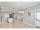 Open concept living room area with tile floors leads into the kitchen and an outdoor patio area at 3906 Carrick Bend Dr, Kissimmee, FL 34746