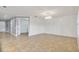 Bright living room with neutral paint and tile floors leads into an open doorway to another room at 3906 Carrick Bend Dr, Kissimmee, FL 34746