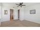 Spacious main bedroom with ceiling fan, carpet flooring, and ensuite bathroom at 3906 Carrick Bend Dr, Kissimmee, FL 34746