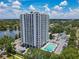Stunning aerial view of high-rise condo with private balconies and a refreshing pool, complemented by lush landscaping and city views at 400 E Colonial Dr # 1501, Orlando, FL 32803