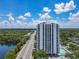 Aerial view of the high-rise building with lush landscaping, community pool and city view at 400 E Colonial Dr # 1501, Orlando, FL 32803