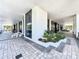Modern building entrance with tiled walkway and various plantings and seating at 400 E Colonial Dr # 1501, Orlando, FL 32803