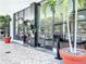 Modern building entrance showcasing floor-to-ceiling windows and manicured landscaping at 400 E Colonial Dr # 1501, Orlando, FL 32803