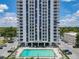 Stunning exterior view of high-rise building with community pool and lounge seating at 400 E Colonial Dr # 1501, Orlando, FL 32803