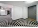 Condo hallway with patterned flooring, white walls, and gray doors with bronze hardware at 400 E Colonial Dr # 1501, Orlando, FL 32803