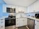 Bright kitchen features stainless steel appliances, white cabinets, and subway tile backsplash at 400 E Colonial Dr # 1501, Orlando, FL 32803