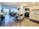 Open concept kitchen with white cabinets, stainless steel appliances, and wood floors at 400 E Colonial Dr # 1501, Orlando, FL 32803